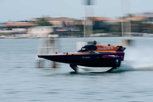 teamrafaXsunreef-web-3 Motion-blurred image of a Sunreef Yachts speedboat in action on the water with 'TEAM RAFA' written on the side.